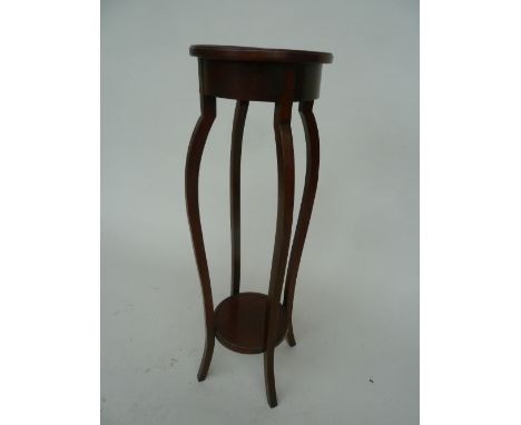 A mahogany torchere with round under shelf 90cmH