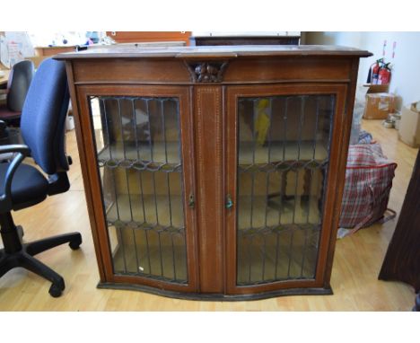 An Edwardian walnut bow fronted display cabinet with leaded doors, 106cm