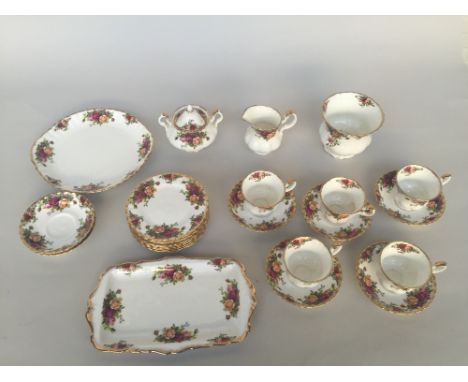 A Royal Albert Old Country Roses service including a sandwich tray, cake plate, sugar bowl, milk jug, five tea cups with seve