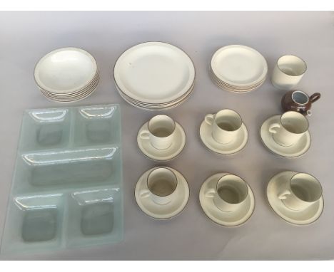 A Poole Pottery oven to table ware part dinner service of cream and bown design including various plates and cups together wi