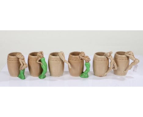 Six Art Deco ceramic mugs, each with stylised handles in the form of nude ladies, each glazed in brown, 11cm high (6)