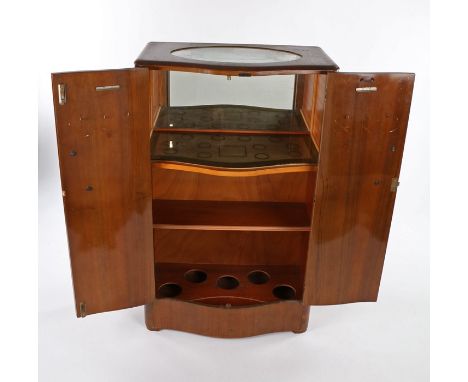 Turnidge walnut veneered drinks cabinet, having a pair of serpentine doors enclosing a mirror and light, with shelf and bottl