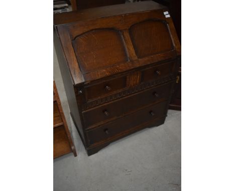 A vintage oak bureau in the Priory style