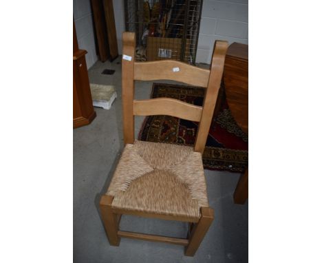 A set of six quality modern/vintage beech ladder back kitchen chairs having rush seats, complimenting the table lot 64, which