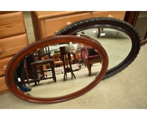 Two vintage oval wall mirrors