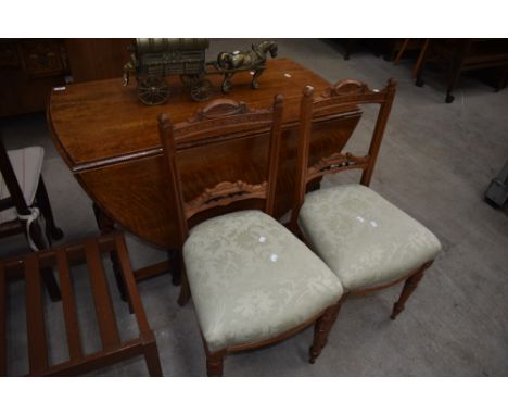 A pair of Victorian parlour chairs in light mahogany with carved and bobbin detail to back, with over stuffed seats and turne