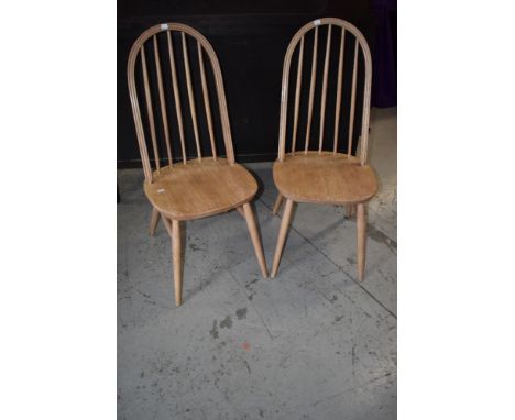 A pair of stripped Ercol style kitchen chairs having hoop and stick back and H stretcher