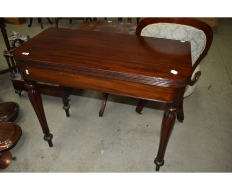 A Victorian mahogany fold over card table and fluted florette legs, width approx. 91cm