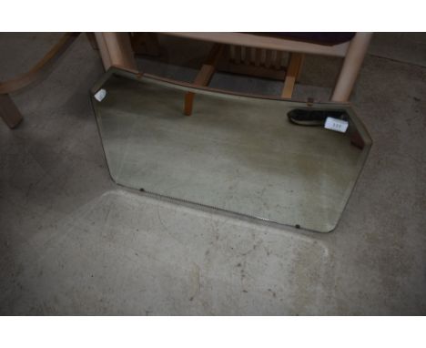 A vintage frameless wall mirror