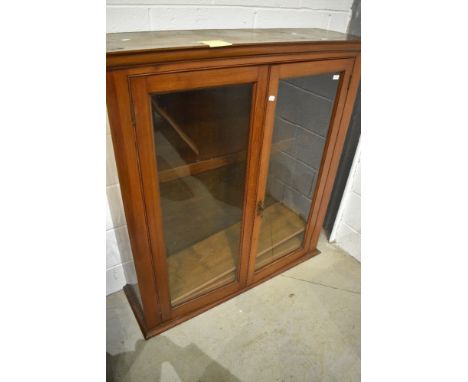 A 19th Century stained pine cased glazed book shelf having rolled plate glass doors