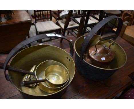 A selection of brass and copperware including jam pans and copper kettle