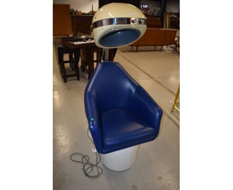 A vintage commercial style hairdryer having blue vinyl seat