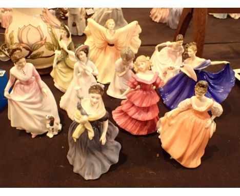 Nine Royal Doulton figurines and one Nao figurine