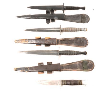 Two "Fairbairn-Sykes" daggers, each with leather scabbard, one marked "Wright, Sheffield", a replica dagger with leather scab