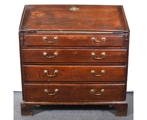 George III oak bureau, fall front enclosing a mahogany fitted interior, four long graduating drawers, bracket feet, width 100