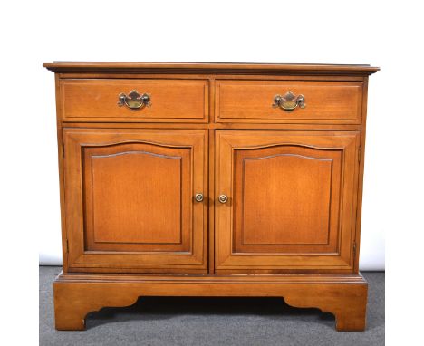 Reproduction walnut cupboard, rectangular top with moulded edge, two drawers over two arched panelled doors, bracket feet, wi