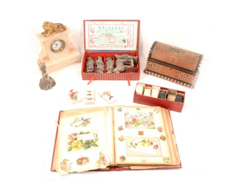A Victorian scrap album and contents; two linen christening gowns; cigarette cards in albums and loose; a set of six horn nap