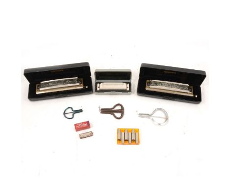 Two Hohner 'Super Chromonica' harmonicas, cased; a Hohner Special 20 Marine Band harmonica, cased; a miniature Hohner No.39 h