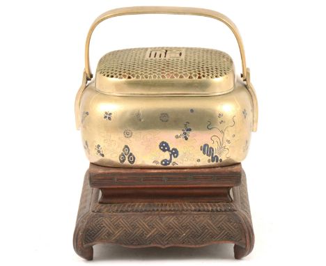 A Japanese censer, basket form with loop handle and pierced cover, the sides tooled with floral border, heightened with black