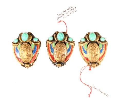 Three dress clips influenced by Egyptian Revival, probably Max Neiger of Gablonz, set with simulated jade cabochons, decorate