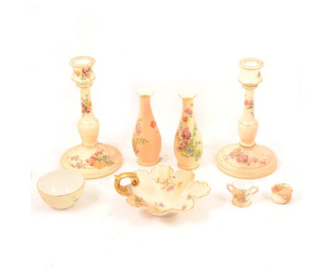 Two Royal Worcester blush ivory candlesticks, 20cm; two vases, 14cm; a small leaf-shaped dish, 15cm; a miniature twin-handled