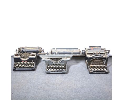 Cast iron doorstop military figure, 38cm, and three vintage typewriters.