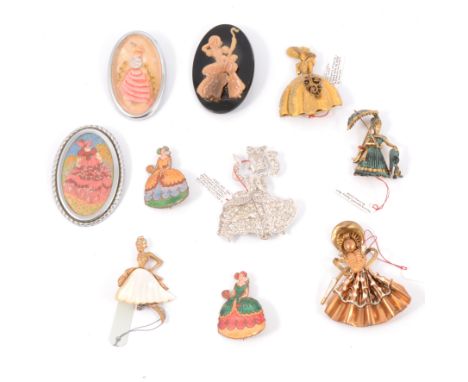 Ten vintage crinoline lady brooches, a paste set 60mm lady, two 40mm enamel pins, lady with a parosol, 50mm, German gilt meta