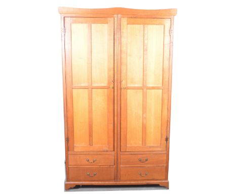 Oak double wardrobe, shaped pediment, two panelled doors above four drawers, bracket feet, hardboard lined, width 121cm, dept