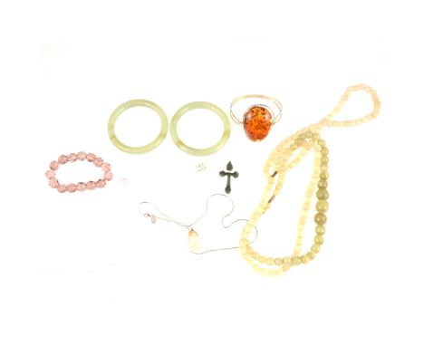 A modern white metal bangle set with a large piece of amber, amber chip earrings, pair of 10mm green stone bangles, internal 