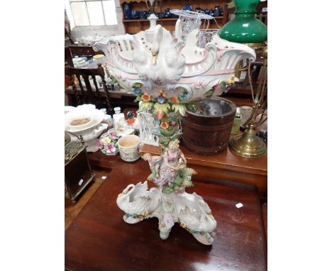 A LARGE EDWARDIAN CONTINENTAL CERAMIC CENTREPIECE decorated with figures and swans, 56cm high