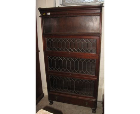 Early 20th Century oak four tier lead glazed sectional bookcase in Globe Wernicke style having under drawer.(B.P. 24% incl. V