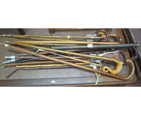 Bundle of assorted walking sticks, shooting stick, walking canes, swagger stick, Alpenstock with ice axe head etc. (B.P. 24% 