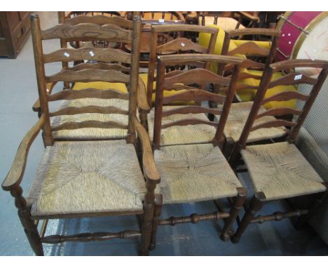 Set of six elm early 20th Century ladder back kitchen chairs on rush seats. (4+2) (6)(B.P. 24% incl. VAT)