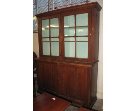 Edwardian arts and crafts design oak cupboard bookcase with two pairs of adjustable shelves and two blind panelled doors on a