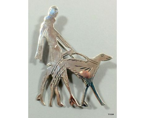 A Silver Art Deco Brooch Depicting A Lady And Her Dog