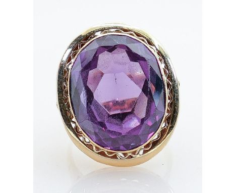High carat ring set very large tanzanite amethyst or similar stone: The stone displays blueish hues in the purple when examin