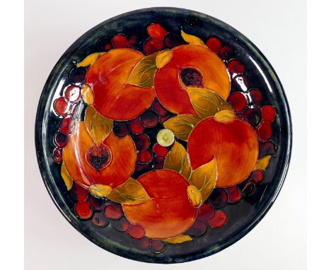 William Moorcroft tazza decorated in the Pomegranate design: On metal stand, d.22cm. 