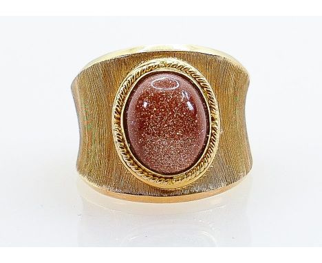 High carat gold ring set cabochon goldstone: Not hallmarked, but tested as 18ct or better, ring size P, weight 8.9g. 