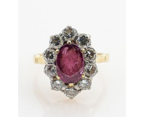 18ct gold ruby &amp; diamond ring: Oval centre ruby surrounded by 10 diamonds, size J, 4.3g. 