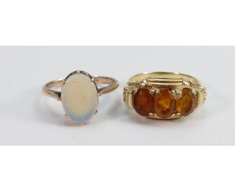 15ct gold ring set with three orange semi precious stones: Size N, 3.7g and yellow metal ring set with oval opal stone, 2.3g.