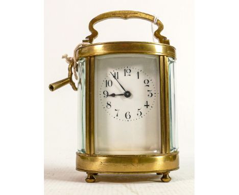 Oval brass cased carriage clock timepiece: Measures 15cm including handle.  Winds, ticks, sets and runs. 