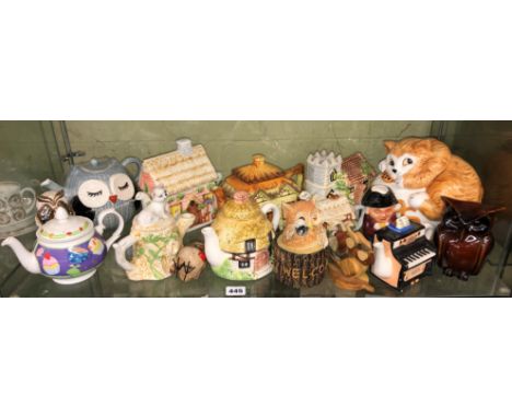 SHELF OF NOVELTY CERAMIC TEAPOTS AND COOKIE JARS