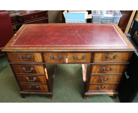 20thC Pedestal desk of 9 drawers with metal drop handles and bracket feet and Red Leather inset top 