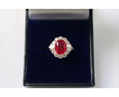 Certificated 18ct white gold oval ruby and diamond cluster ring. Ruby 2.05ct. RBC and baguette diamonds 0.85ct. Cert no. WGI9