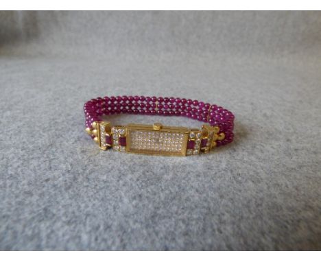 Van Cleef and Arpel diamond and ruby lady's quartz watch, the dial pave set with brilliant cuts, with diamond and ruby, baton