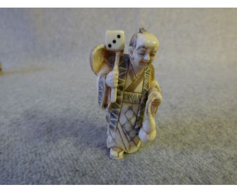 Chinese carved ivory netsuke figure with a dice