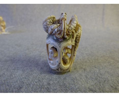 Chinese carved ivory netsuke of a dragon and figures