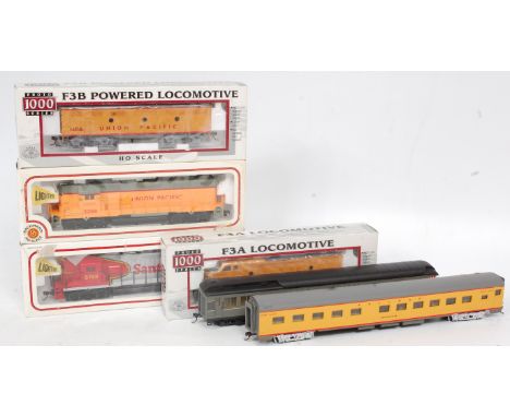 A Bachmann USA H0 EMD GP-50 Bo-Bo diesel in Santa Fe red/silver (G-NM,BG), another in Union Pacific yellow (G-NM,BG), a Proto