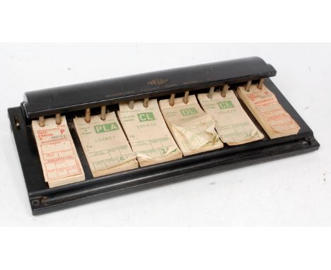 A railway luggage desktop ticker dispenser made of Bakelite, to comprise of six rows of luggage labels, made by Westinghouse 