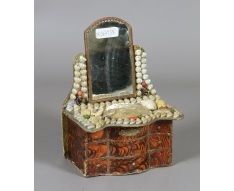 A trinket box formed as a dressing table and ornamented with applied shells. 